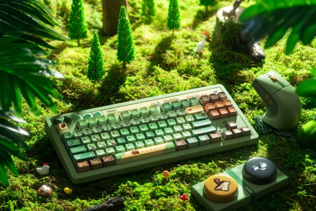 8BitDo Retro 87 mechanical keyboard and retro mouse in the Forest Wonder colorway on a wooden desk with the Ultimate 3 controller