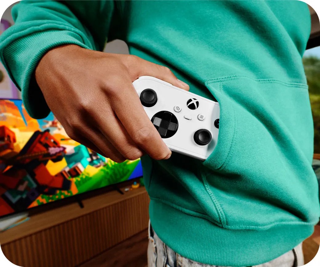 A teenager pulling the Xbox Nano Controller out of a sweatshirt front pocket