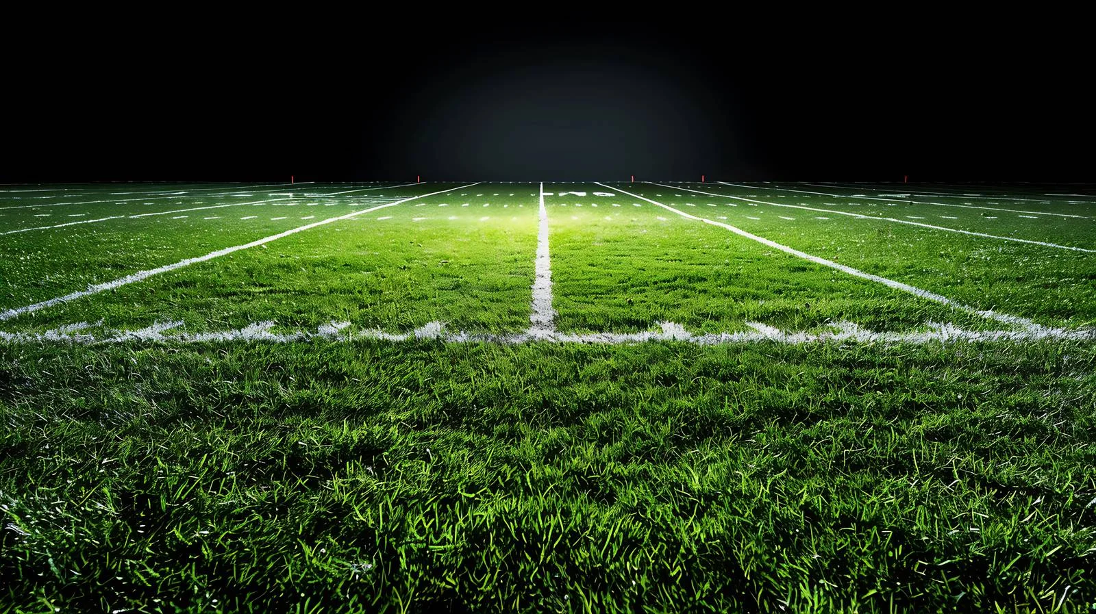 Nighttime College Football on Grass Field with Light Spotlight — free download from Dotvec