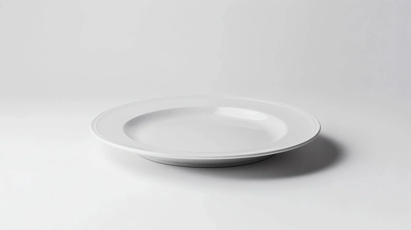 Minimalist white plate on isolated white surface — free download from Dotvec
