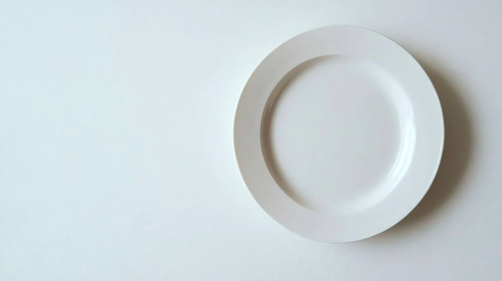 Minimalist White Plate on Clean White Surface — free download from Dotvec