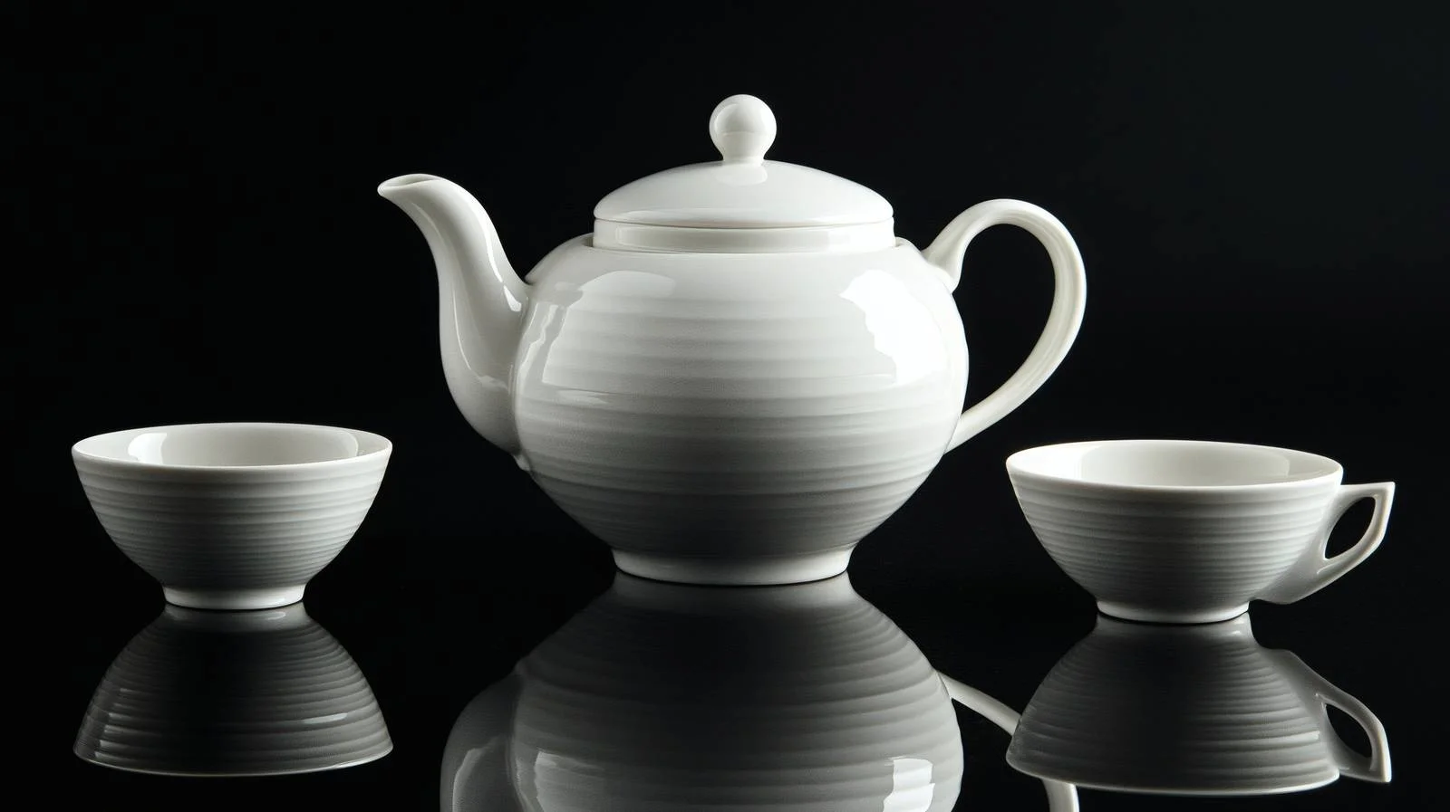 Elegant Teapot and Teacups on Black Background — free download from Dotvec