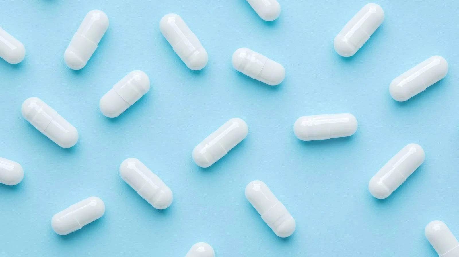 Pharmaceutical Pills on Blue Background Isolated — free download from Dotvec