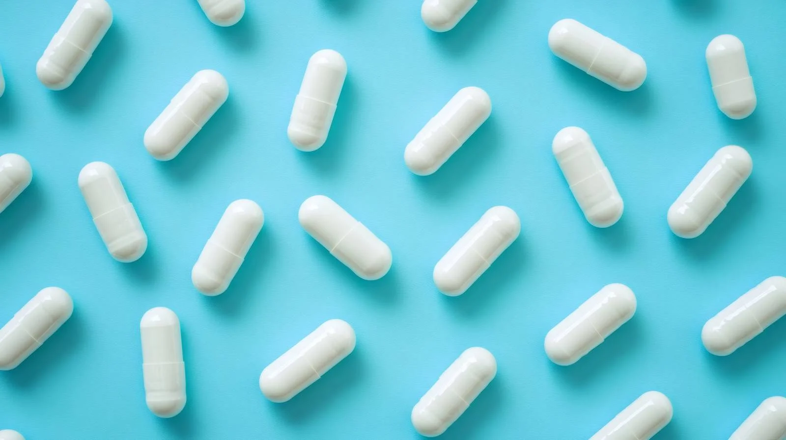 Clinical capsules on blue backdrop — free download from Dotvec