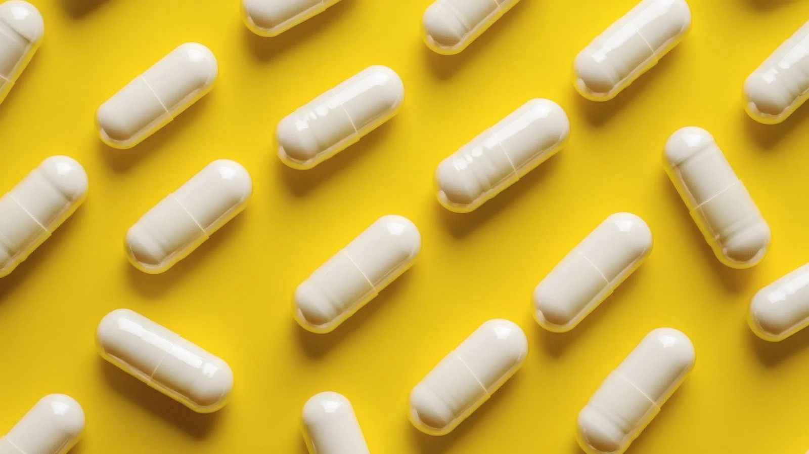 Health Supplements Capsules on Yellow Background — free download from Dotvec