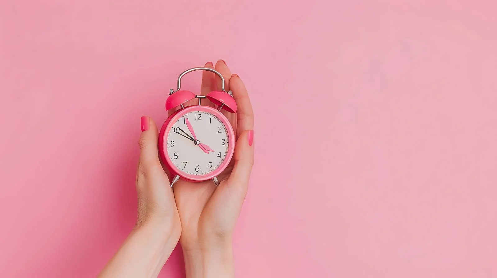 Woman Holding Alarm Clock on Pink Background — free download from Dotvec