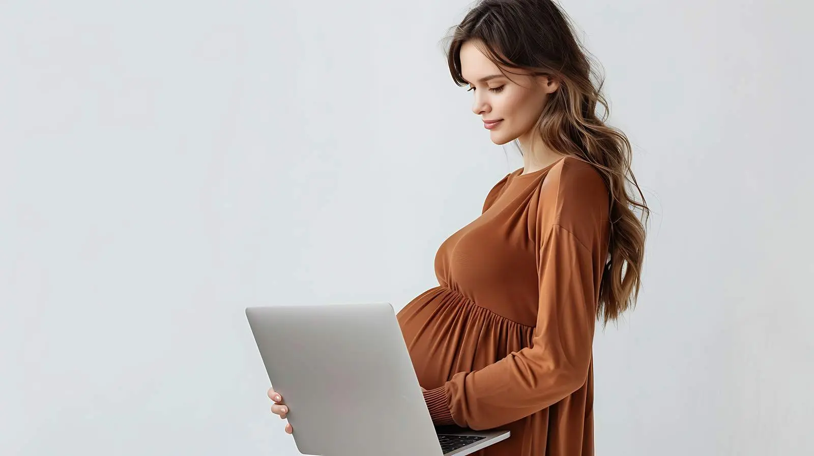 Pregnant Woman in Brown Dress Working on Laptop — free download from Dotvec