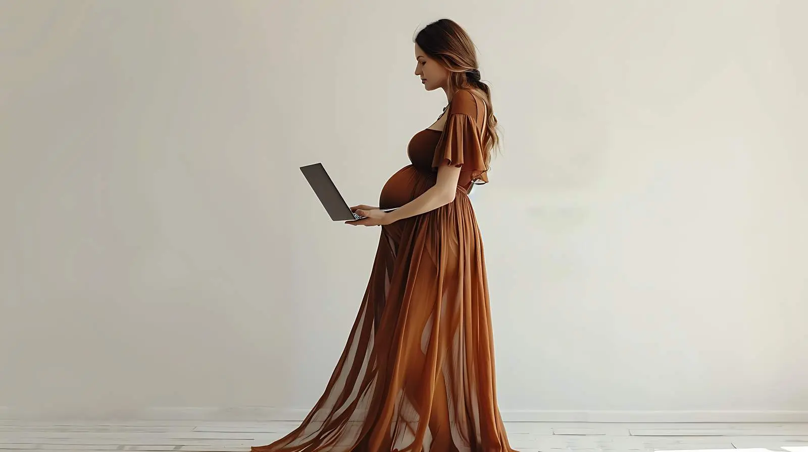 Young Pregnant Woman Working on Laptop in Brown Dress — free download from Dotvec