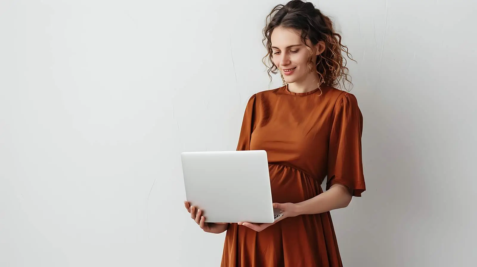 Pregnant Woman in Brown Dress Working on Laptop — free download from Dotvec