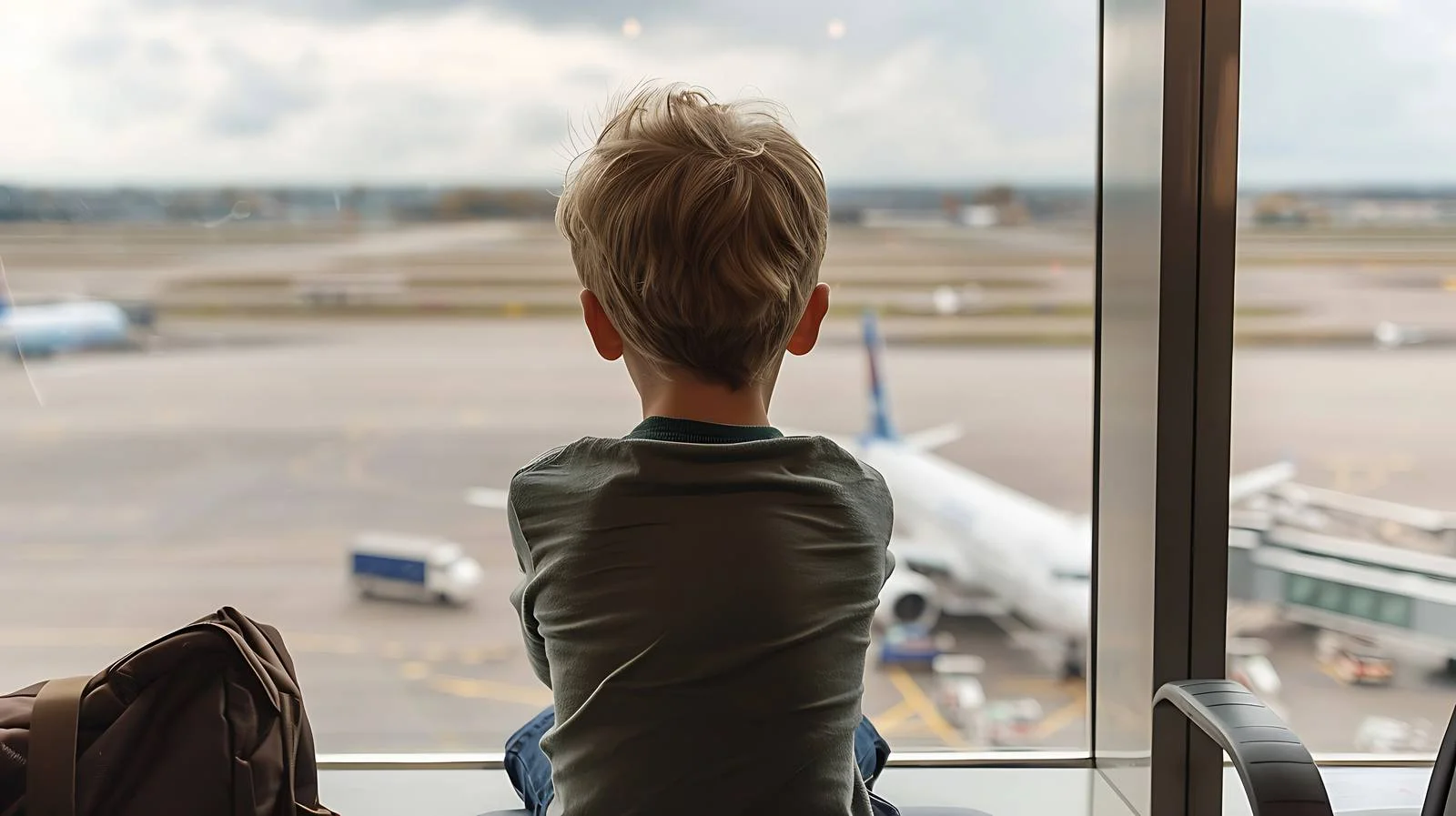 Young Traveler Observing Planes at Airport — free download from Dotvec