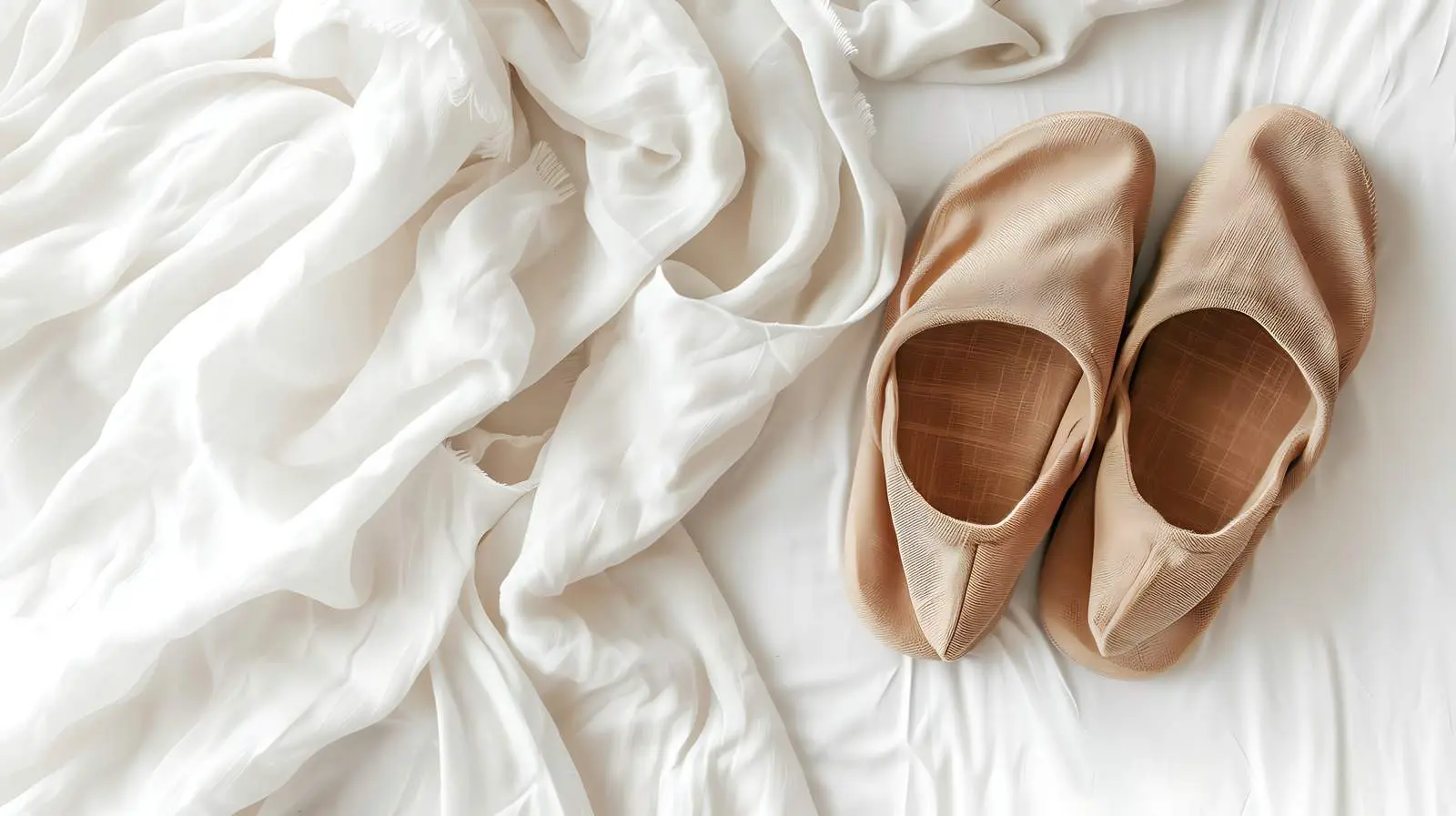 Cozy Brown Slippers on Crumpled White Linen — free download from Dotvec