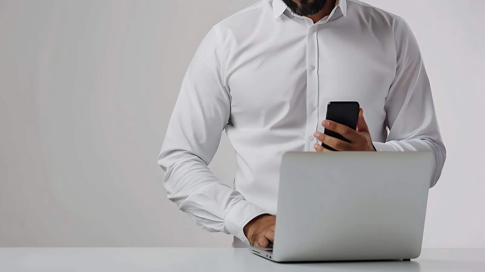 Businessman Using Smartphone and Laptop at Workplace — free download from Dotvec