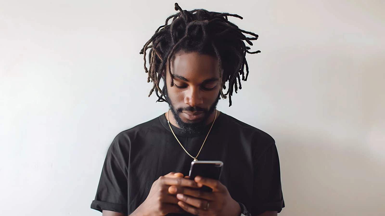 Close-up of Man with Locs Using Phone — free download from Dotvec