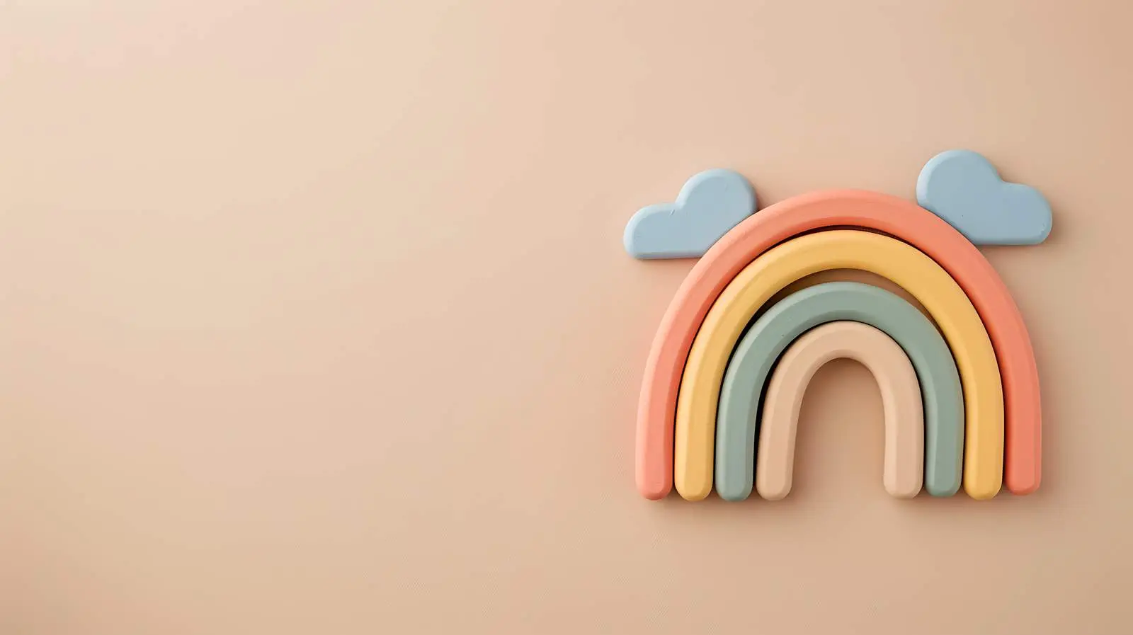Vibrant Rainbow Stacking Toy on Beige Background – free infant image from Dotvec