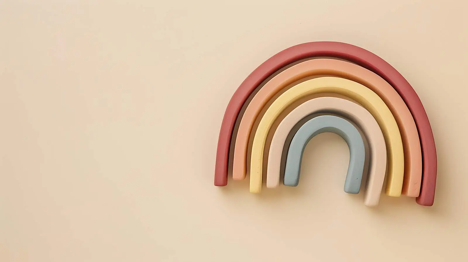 Colorful Rainbow Stacking Toy on Beige Background – free infant image from Dotvec