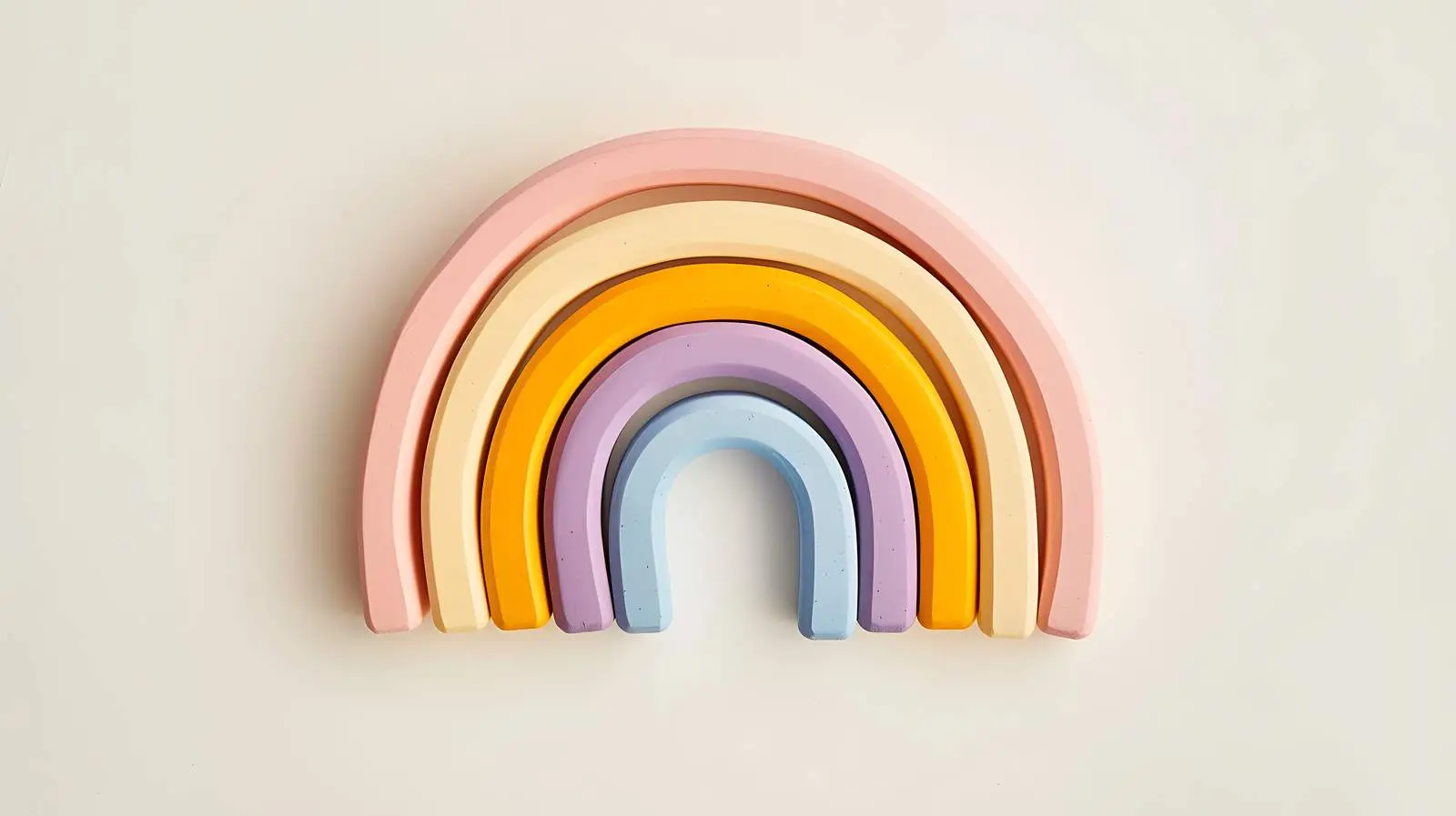 Colourful Rainbow Stacking Toy on Beige Background – free infant image from Dotvec