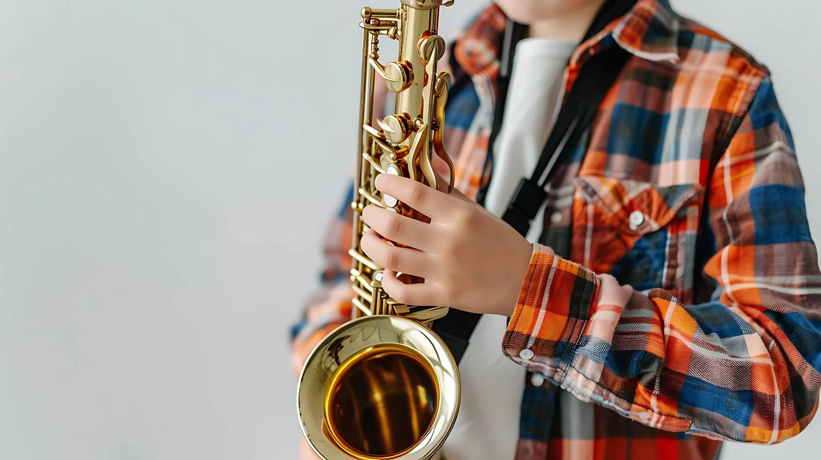 Young boy practicing saxophone with coach — free download from Dotvec