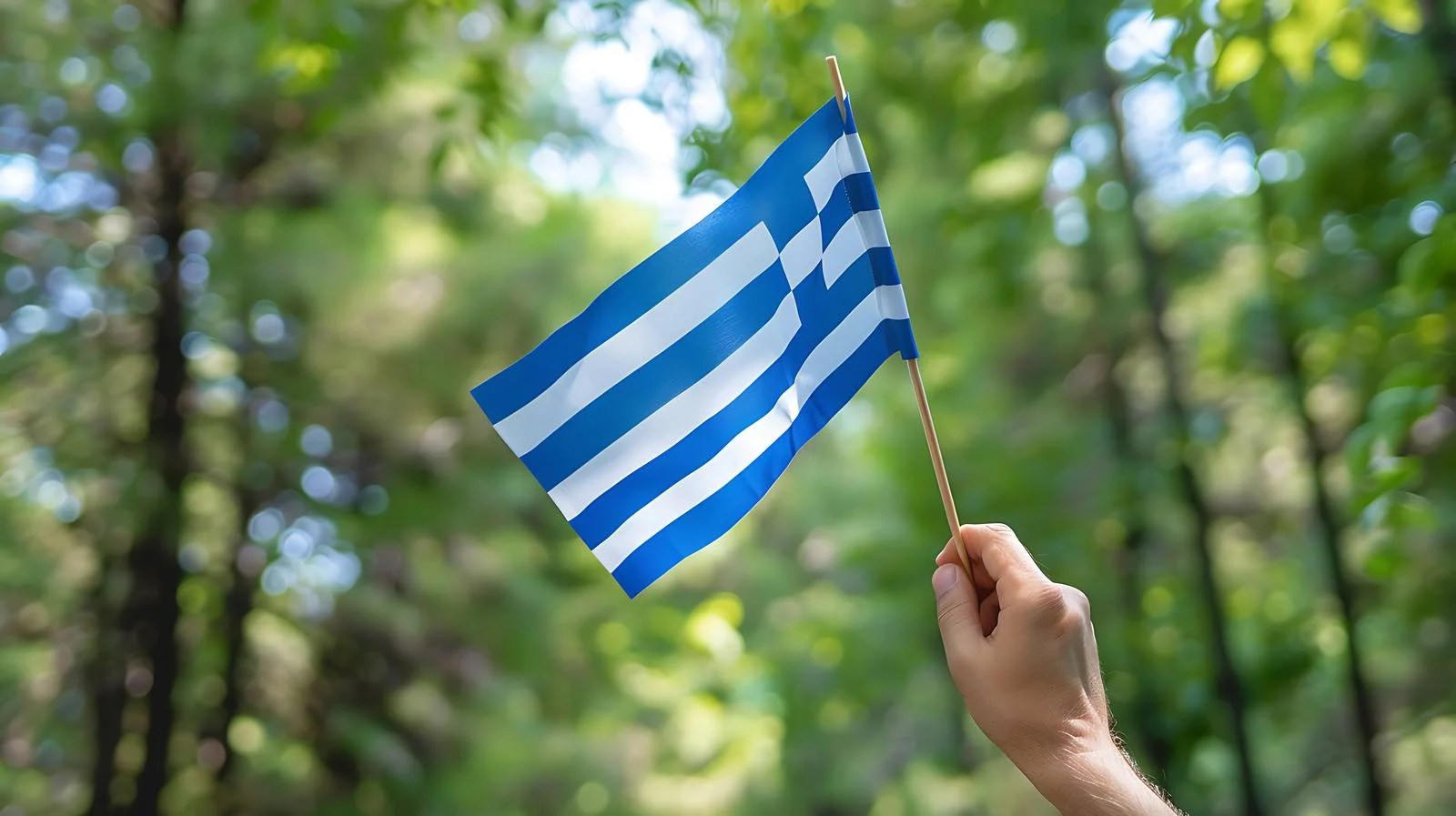 Greek Flag Held in Nature Background – free greece image from Dotvec