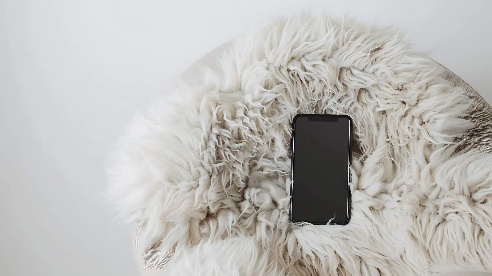 Flatlay of Mobile Phone on Woolen Chair – free soft furnishings image from Dotvec