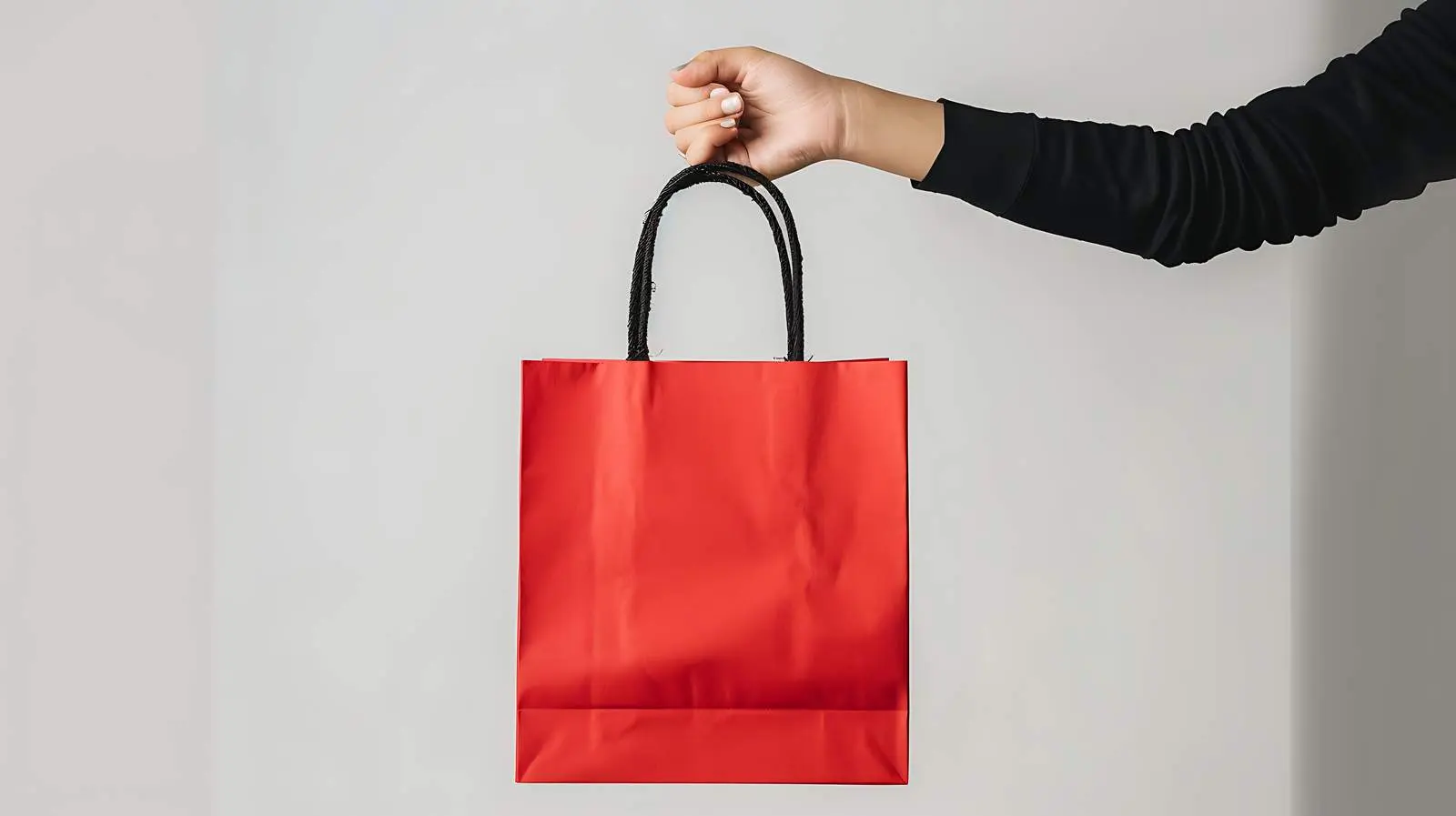 Hand Holding Red Craft Shopping Bag with Sale Sign — free download from Dotvec