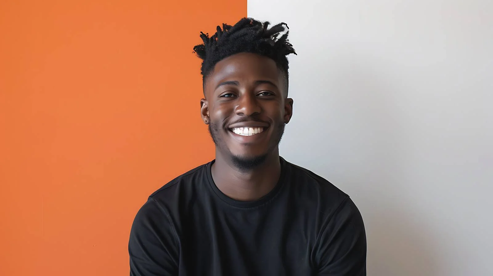 Stylish young man smiling near orange — free download from Dotvec