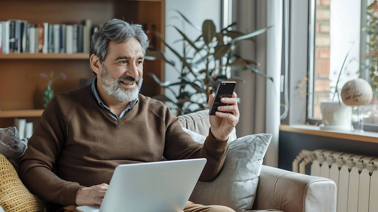 Focused Man Using Smartphone Sitting — free download from Dotvec