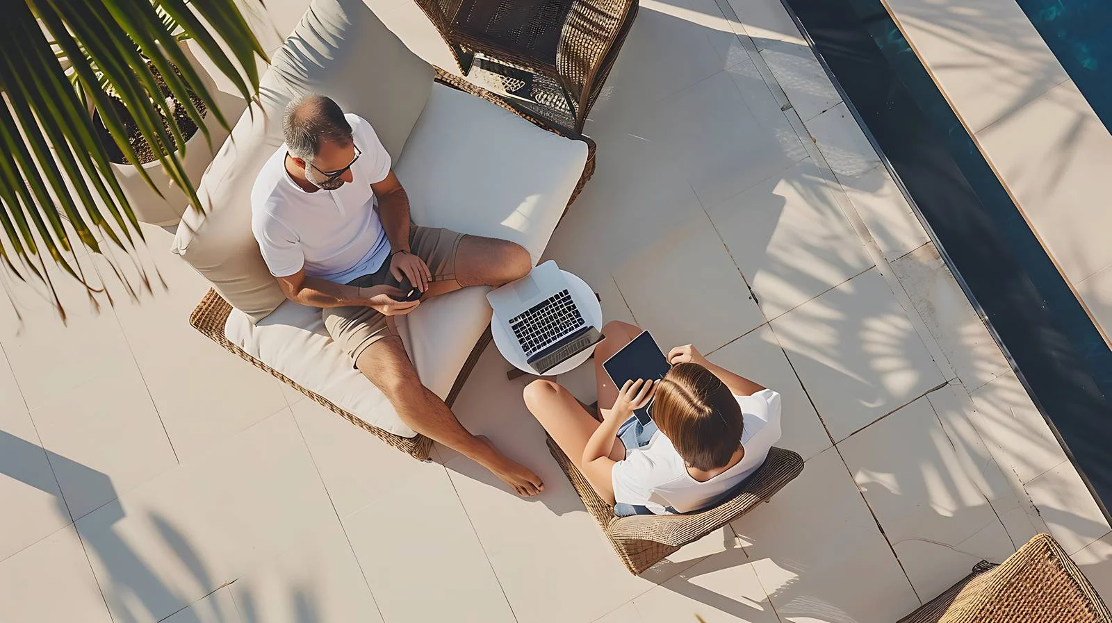 Man on terrace working on laptop — free download from Dotvec