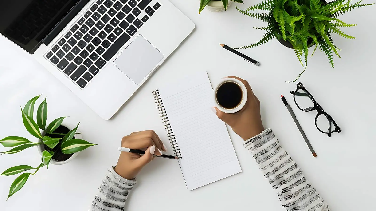 Person Writing in Notebook on Paper Sheet — free download from Dotvec