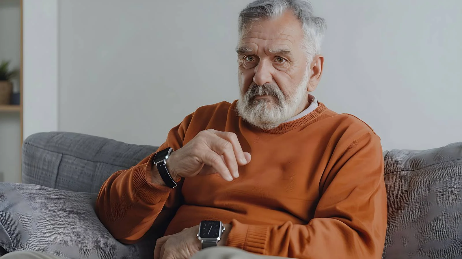 Elderly gentleman on sofa using smartwatch — free download from Dotvec