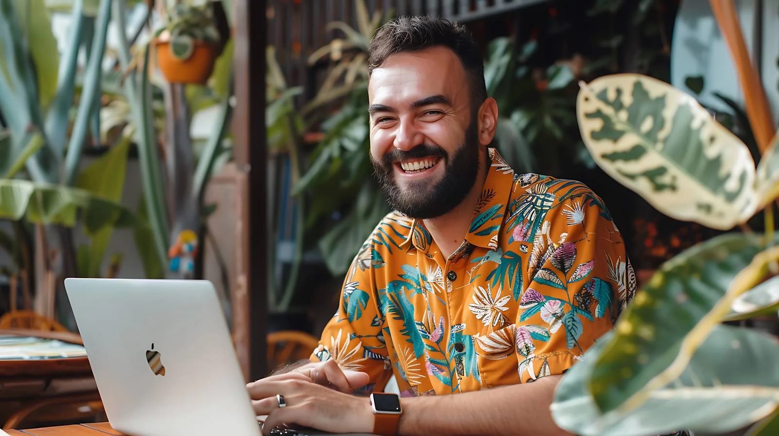 Man Smiling on Terrace with Laptop — free download from Dotvec