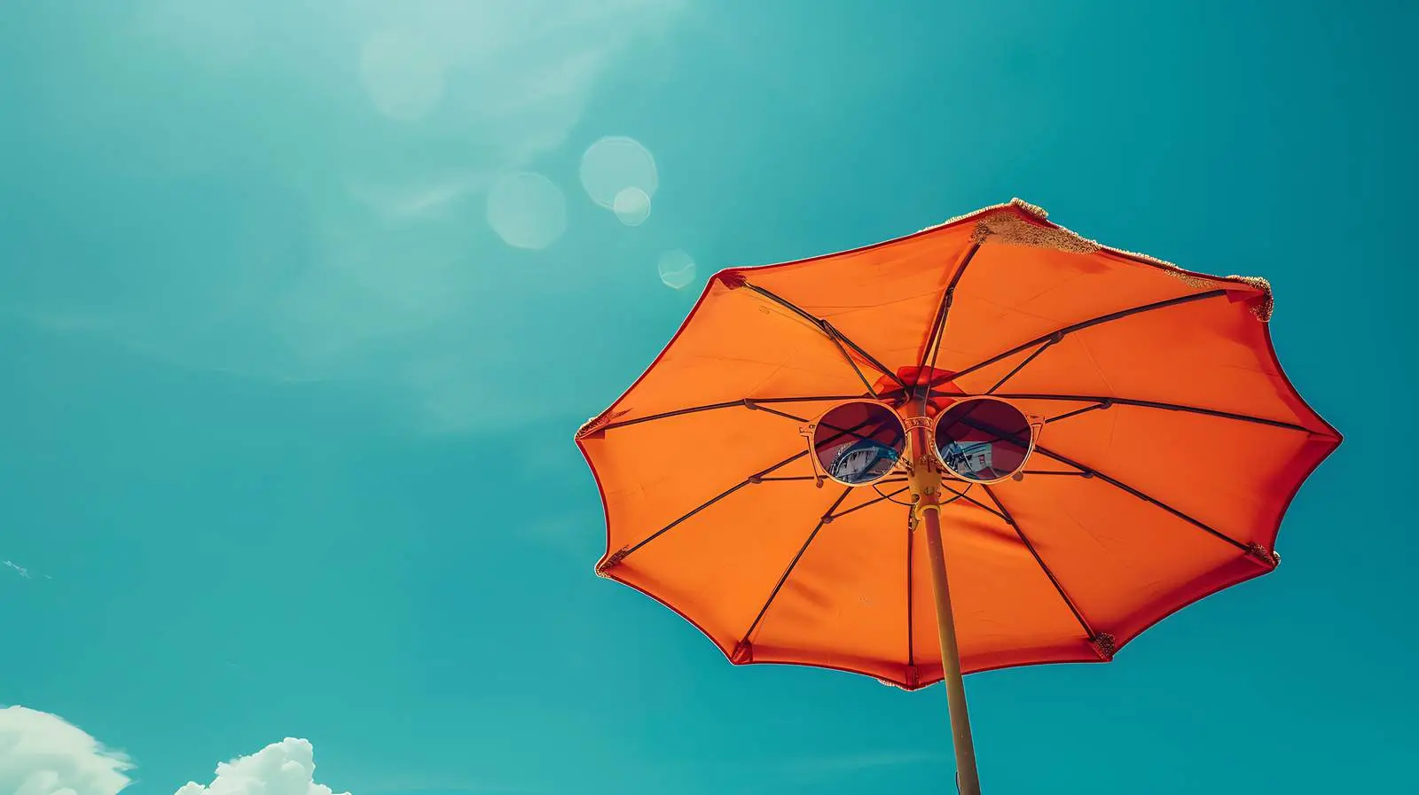Sunglasses and Beach Umbrella Under Clear Sky — free download from Dotvec