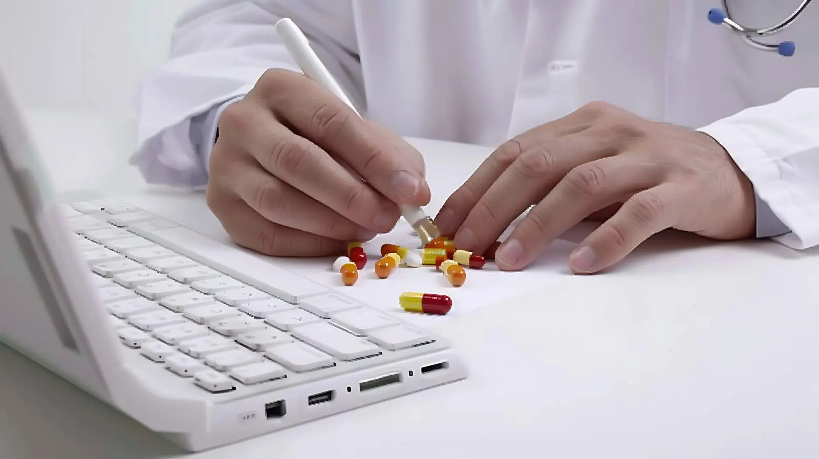 Doctor Writing Prescription on Computer – free medical technology image from Dotvec