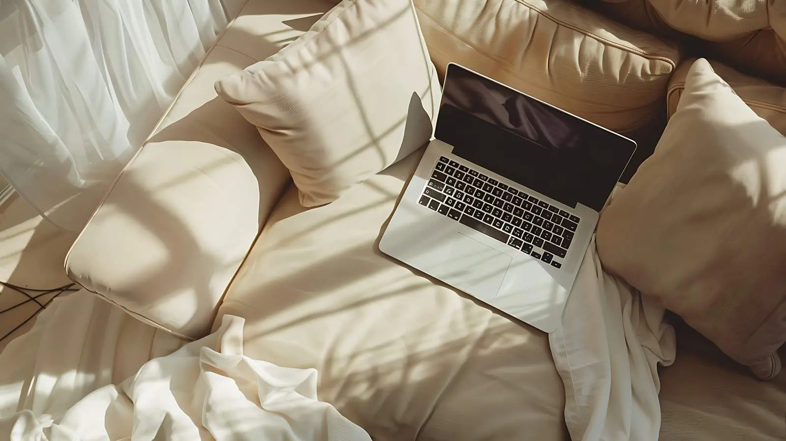 Laptop on Neutral Beige Couch with Pillows — free download from Dotvec