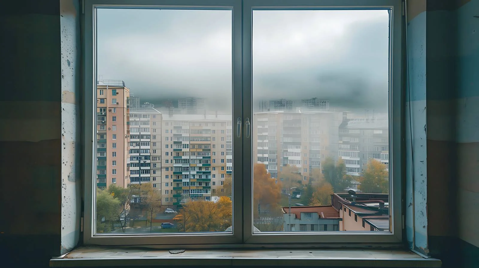Urban buildings seen through misty windowpane — free download from Dotvec