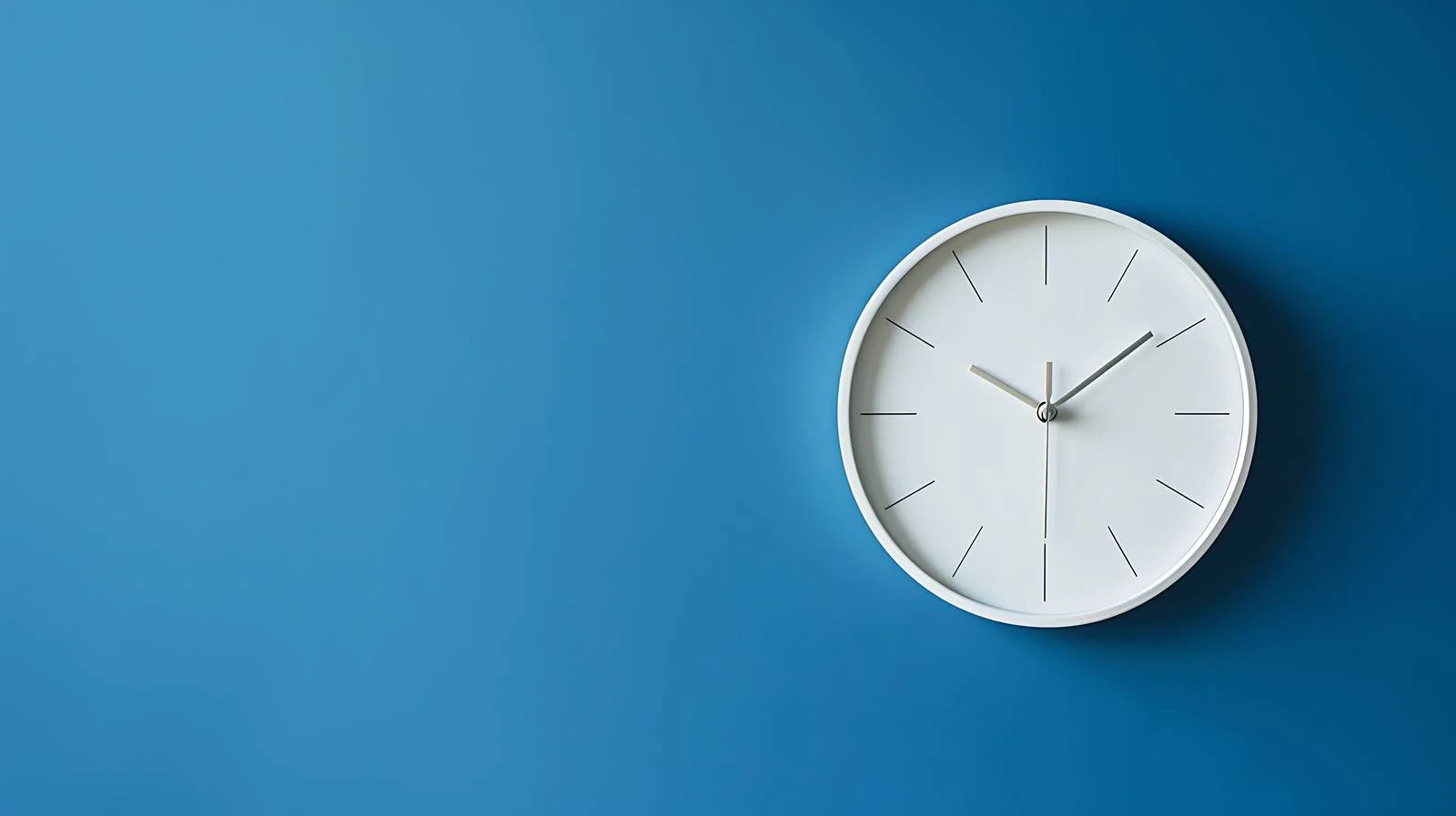 Minimalistic White Clock on Blue Wall — free download from Dotvec