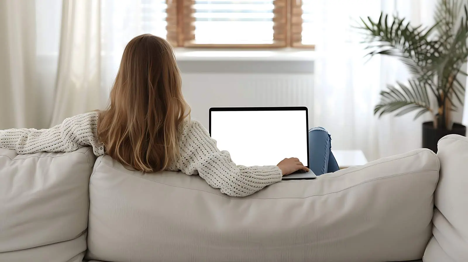Woman Using Laptop on Sofa — free download from Dotvec