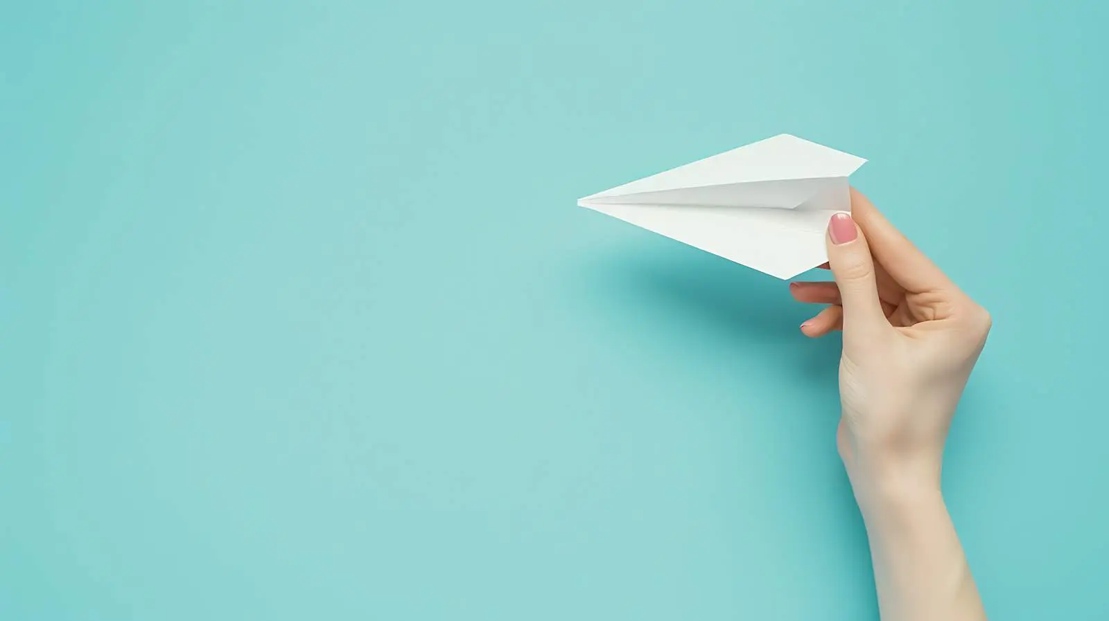 Woman Holding Paper Plane on Blue Background — free download from Dotvec