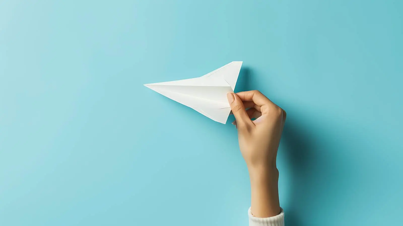 Woman Holding Paper Plane on Blue Background – free reams image from Dotvec