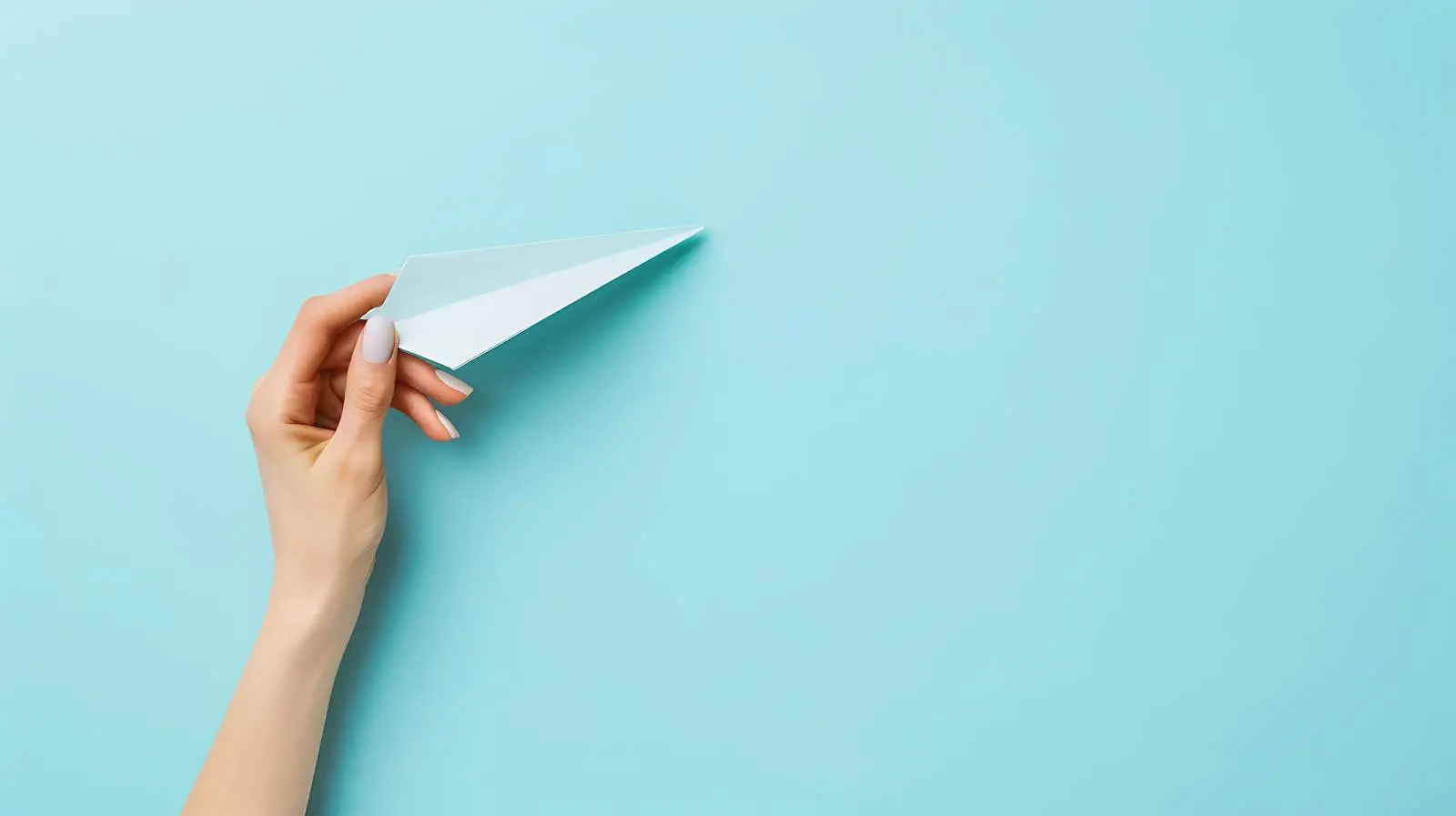 Woman Holding Paper Plane on Blue Background — free download from Dotvec