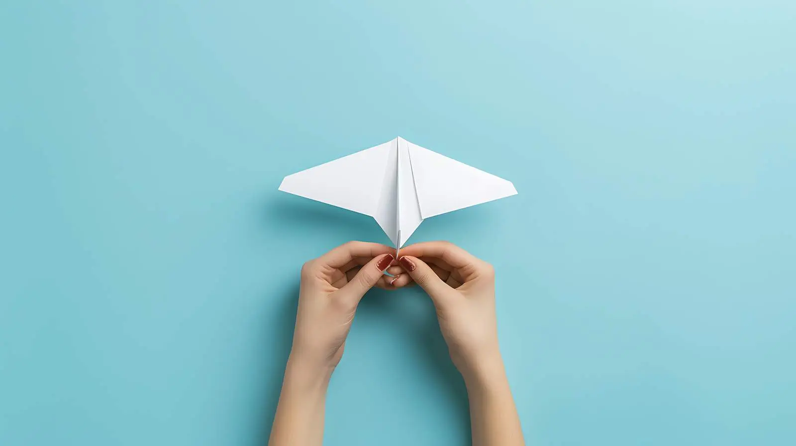 Woman Holding Paper Plane on Pale Blue Background – free smile image from Dotvec