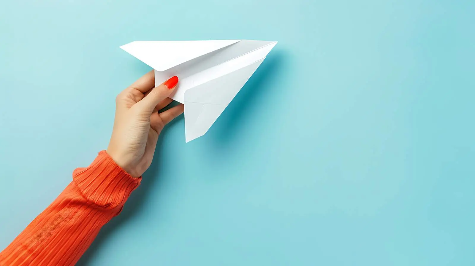 Woman Holding Paper Plane on Pale Blue Background – free empowerment image from Dotvec