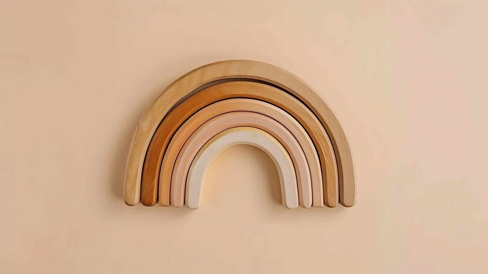 Wooden Rainbow Stacking Toy on Soft Beige Background – free neutral palette image from Dotvec