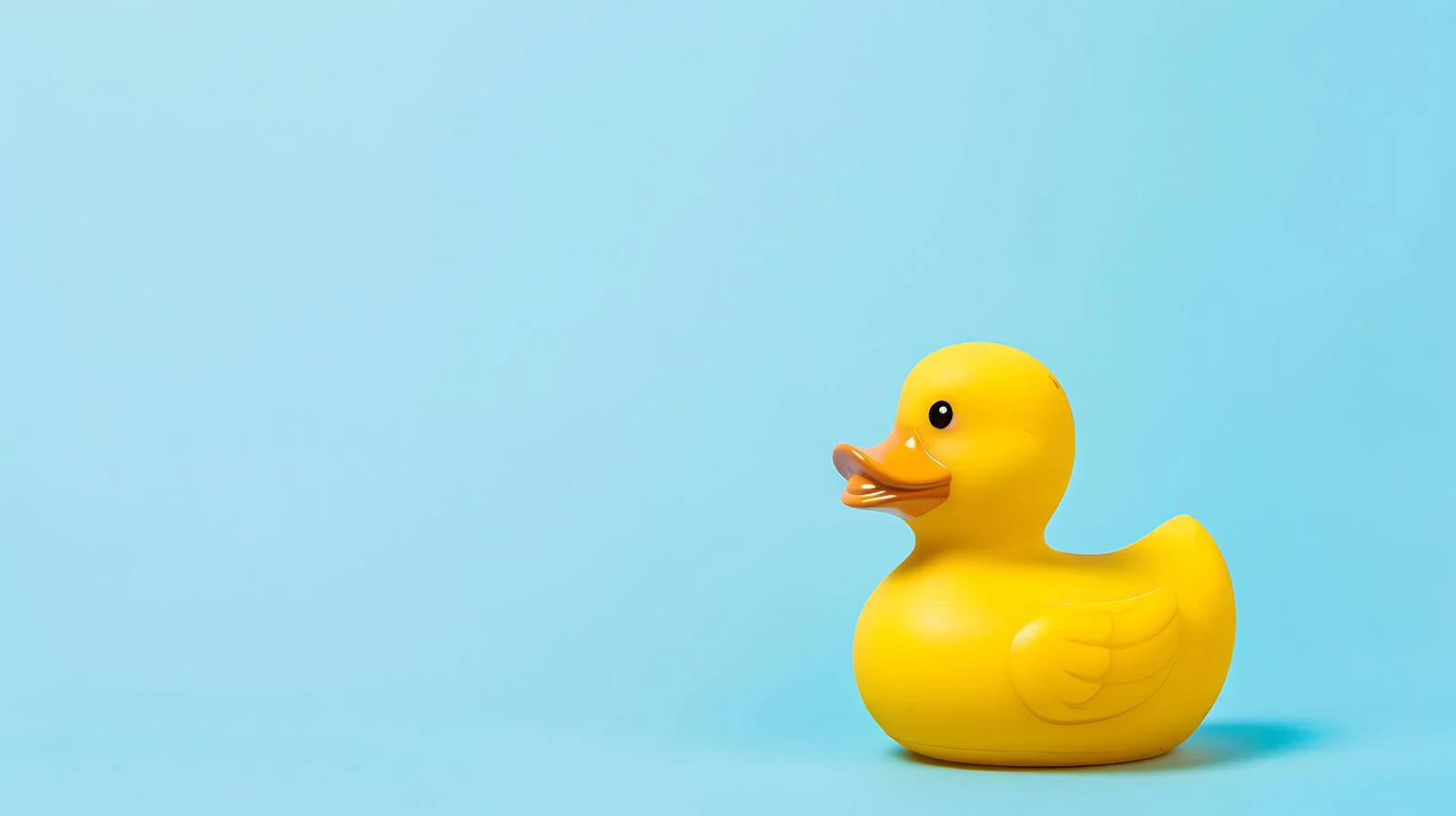Vibrant Rubber Duck on Blue Background — free download from Dotvec