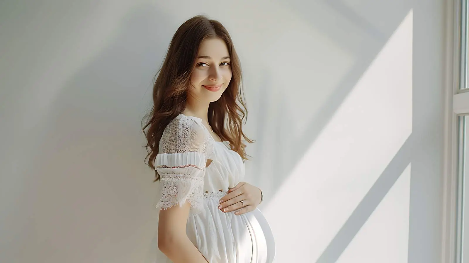 Pregnant Woman Near White Wall — free download from Dotvec