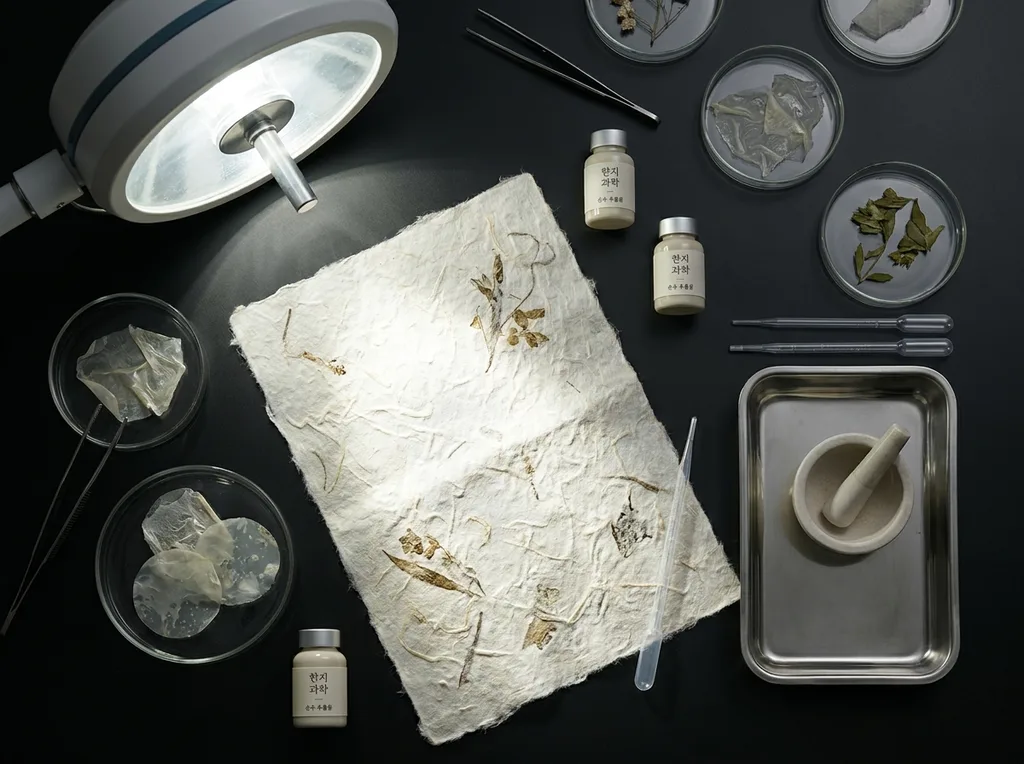 A sterile but organic laboratory environment where traditional hanji paper meets modern scientific observation