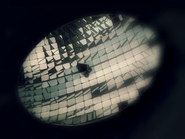 a circular concave metal dish consisting of many square mirrors