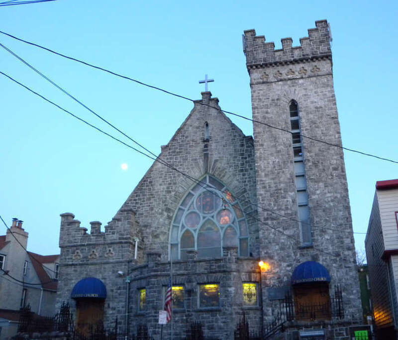 Looking east across Summit Avenue at Second Reformed Church of Jersey City in twilight of a clear evening with the Moon rising behind.