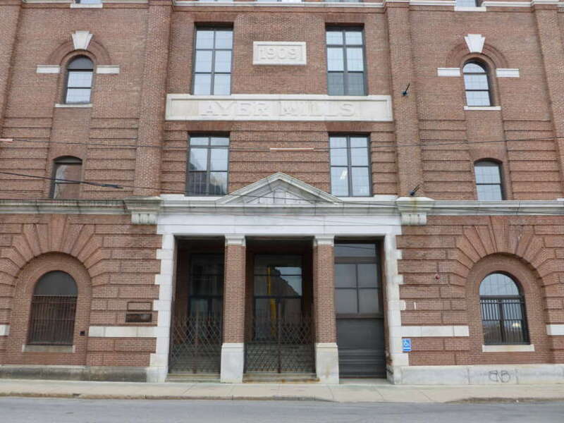 The east entrance of one of the Ayer Mills, located on the corner of Merrimack Street and the west side of South Union Street, in Lawrence, Massachusetts.  Stone molding above the entrance reads "1909".