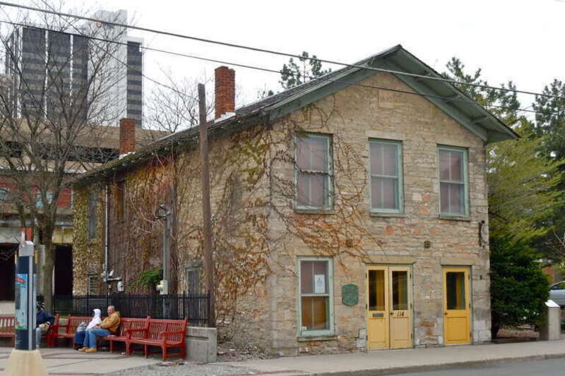 John Brown Stone Warehouse on the NRHP since December 15, 1997. At 114 W. Superior St., Fort Wayne, Allen County, Indiana.  Datestone near peak of roof says 1852.  Historic plaque near doors, major downtown bus stop to the left.