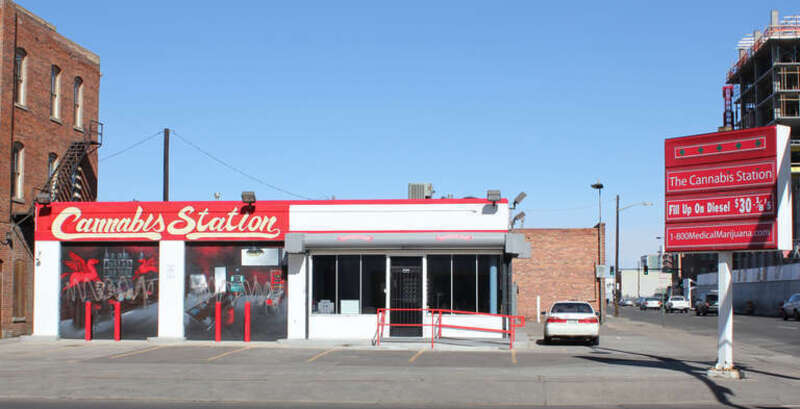 Cannabis Station, a medical marijuana dispensary located at the intersection of Lawrence Street and 20th Avenue in Denver, Colorado. The shop occupies a former gas station. Part of the text on the sign says, "Fill Up on Diesel $30 ⅛'s."